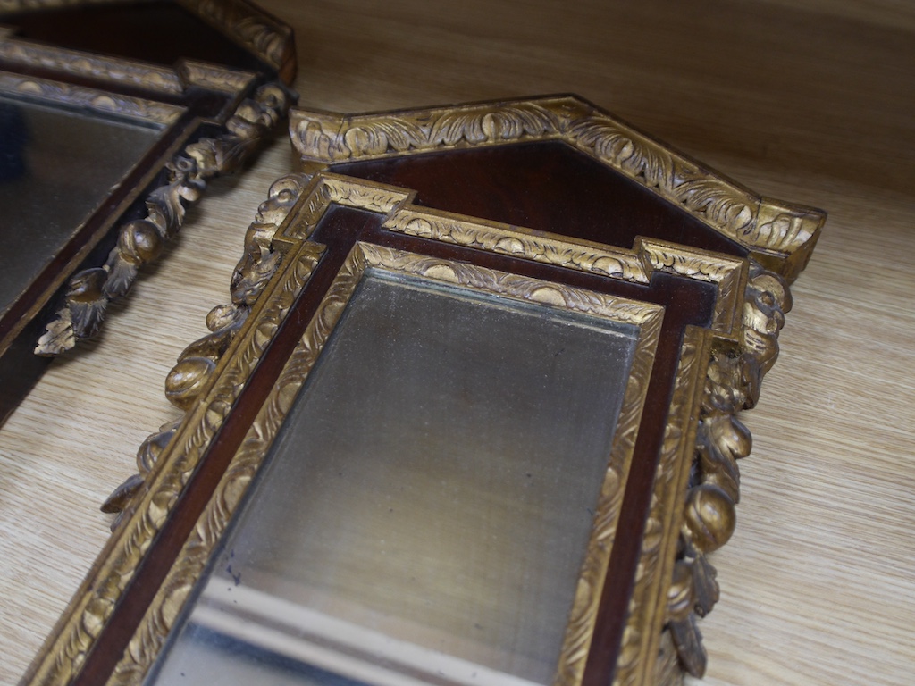 A pair of late 19th / early 20th century mahogany pier glass mirrors in George II style, 75 x 33cm. Condition - fair